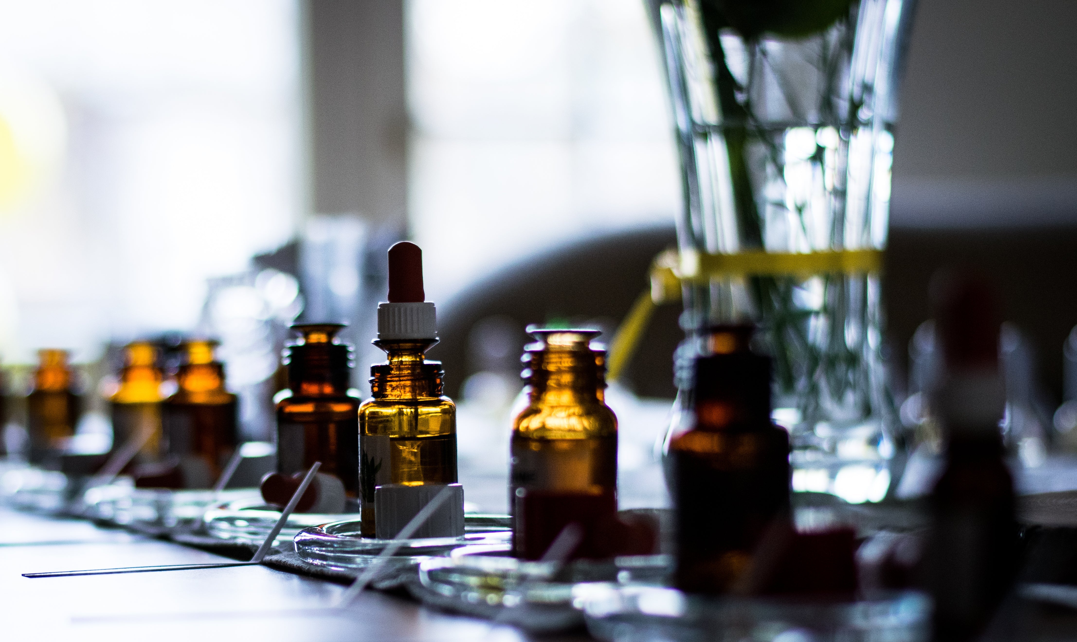 Row of amber essential oil dropper bottles at Sifr Aromatics, Singapore