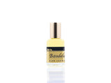 15ml roller ball oil perfume bottle placed elegantly on a white background. The bottle is sleek and cylindrical, with a smooth glass body and a polished metal roller ball at the top. The label on the bottle is designed in gold and black, featuring Sifr Aromatics' logo and the perfume name 'Baudelaire.' The overall aesthetic is clean and sophisticated, highlighting the high-quality craftsmanship of the product