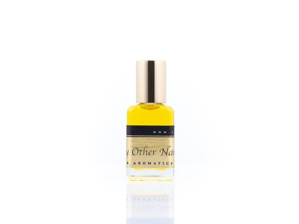 15ml roller ball oil perfume bottle placed elegantly on a white background. The bottle is sleek and cylindrical, with a smooth glass body and a polished metal roller ball at the top. The label on the bottle is designed in gold and black, featuring Sifr Aromatics' logo and the perfume name 'By Other Any Name.' The overall aesthetic is clean and sophisticated, highlighting the high-quality craftsmanship of the product