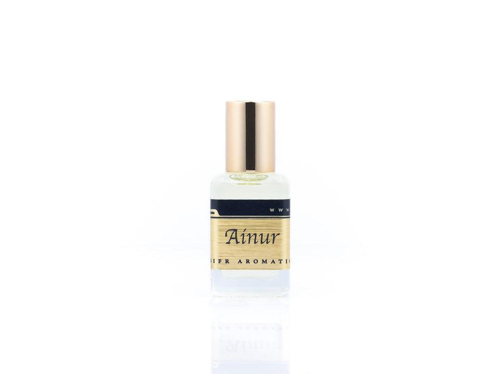 15ml roller ball oil perfume bottle placed elegantly on a white background. The bottle is sleek and cylindrical, with a smooth glass body and a polished metal roller ball at the top. The label on the bottle is designed in gold and black, featuring Sifr Aromatics' logo and the perfume name 'Ainur.' The overall aesthetic is clean and sophisticated, highlighting the high-quality craftsmanship of the product.